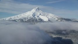 5.5K aerial stock footage of a snow-capped mountain peak and low clouds, Mount Hood, Cascade Range, Oregon Aerial Stock Footage | AX154_117