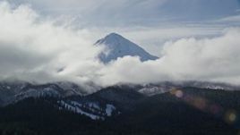 5.5K aerial stock footage of clouds around the snowy summit of Mount Hood, Cascade Range, Oregon Aerial Stock Footage | AX154_131E