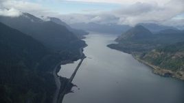 5.5K aerial stock footage approaching the I-84 highway at the base of mountains in Columbia River Gorge Aerial Stock Footage | AX154_156