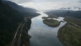 5.5K aerial stock footage following Columbia River and I-84 highway, flyby islands in Columbia River Gorge Aerial Stock Footage | AX154_179E