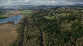 5.5K aerial stock footage flying over railroad tracks and Highway 14 through forest in Washougal, Washington Aerial Stock Footage | AX154_199E