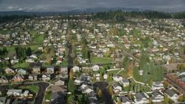 5.5K aerial stock footage tilting from the roof of Washougal High School to reveal suburban neighborhoods in Washougal, Washington Aerial Stock Footage | AX154_203