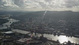 5.5K aerial stock footage flying by the Willamette River and Downtown Portland, Oregon with godrays shining down Aerial Stock Footage | AX154_227