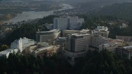 5.5K aerial stock footage flying away from the Oregon Health and Science University complex in the hills over Portland, Oregon Aerial Stock Footage | AX154_248