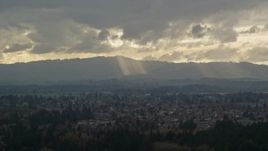 5.5K aerial stock footage of Cascade Range and godrays shining from clouds seen from suburban neighborhood, Beaverton, Oregon Aerial Stock Footage | AX155_007