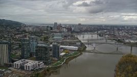 5.5K aerial stock footage flying over Willamette River and Ross Island to approach South Waterfront and Downtown Portland, Oregon Aerial Stock Footage | AX155_025E