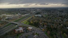 5.5K aerial stock footage flying over suburban homes to approach apartment buildings and follow Highway 26 in Beaverton, Oregon, twilight Aerial Stock Footage | AX155_126E