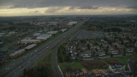5.5K aerial stock footage flying over fly over apartment buildings and follow Highway 26 by Tanasbourne Town Center in Hillsboro, Oregon, twilight Aerial Stock Footage | AX155_127