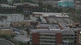 5.5K aerial stock footage flying by office buildings and reveal apartment buildings in Hillsboro, Oregon, twilight Aerial Stock Footage | AX155_129