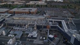 5.5K aerial stock footage flying over Intel Ronler Acres Campus at twilight to approach and fly over warehouse buildings, in Hillsboro, Oregon Aerial Stock Footage | AX155_133