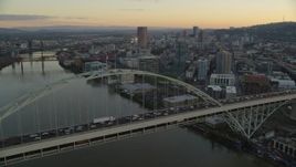 5.5K aerial stock footage of heavy traffic crossing the Fremont Bridge at twilight, and Downtown Portland skyscrapers in the background Aerial Stock Footage | AX155_160