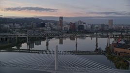 5.5K aerial stock footage of Downtown Portland skyline seen while flying by Willamette River bridges at twilight, Oregon Aerial Stock Footage | AX155_190E