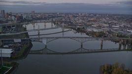 5.5K aerial stock footage of Ross Island Bridge and Willamette River bridges at twilight, reveal Downtown Portland, Oregon Aerial Stock Footage | AX155_197E