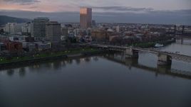5.5K aerial stock footage flying over Morrison Bridge, and pass the waterfront park and downtown skyline at twilight, Downtown Portland, Oregon Aerial Stock Footage | AX155_203
