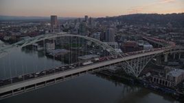 5.5K aerial stock footage orbiting heavy rush-hour traffic on both decks of the Fremont Bridge, and reveal Downtown Portland, Oregon, twilight Aerial Stock Footage | AX155_208E