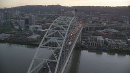5.5K aerial stock footage orbiting heavy traffic on both decks of the Fremont Bridge, and reveal Downtown Portland, Oregon, twilight Aerial Stock Footage | AX155_210