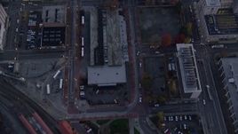 5.5K aerial stock footage of a bird's eye view of bus station and downtown buildings between NW 5th and 6th Avenue at twilight, Downtown Portland, Oregon Aerial Stock Footage | AX155_221