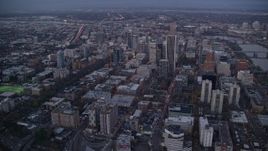 5.5K aerial stock footage flying over streets toward Wells Fargo Center and tilt down at twilight, Downtown Portland, Oregon Aerial Stock Footage | AX155_228
