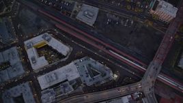 5.5K aerial stock footage of a bird's eye view of buildings between NW 6th Avenue NW 5th Avenue at twilight, reveal Greyhound bus station, Downtown Portland, Oregon Aerial Stock Footage | AX155_234E