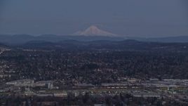 5.5K aerial stock footage of Mount Hood at twilight, seen from a train yard and neighborhoods in Southeast Portland, Oregon Aerial Stock Footage | AX155_248
