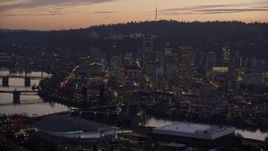 5.5K aerial stock footage of Downtown skyscrapers and the Willamette River at twilight seen from Moda Center, Downtown Portland, Oregon Aerial Stock Footage | AX155_259
