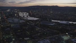 5.5K aerial stock footage approaching Moda Center, Willamette River, and downtown skyscrapers at twilight, Downtown Portland, Oregon Aerial Stock Footage | AX155_260