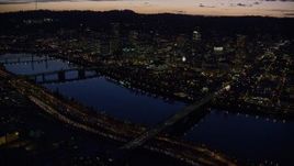 5.5K aerial stock footage of Downtown skyscrapers, Burnside Bridge, and White Stag sign at night, Downtown Portland, Oregon Aerial Stock Footage | AX155_296