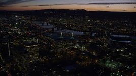 5.5K aerial stock footage flying over convention center to approach the Willamette River and Downtown Portland at night in Oregon Aerial Stock Footage | AX155_299E