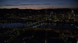 5.5K aerial stock footage of Downtown Portland skyscrapers at night seen across the Hawthorne Bridge and Willamette River, Oregon Aerial Stock Footage | AX155_320E