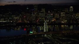 5.5K aerial stock footage of Downtown Portland skyscrapers at night across the Hawthorne Bridge spanning Willamette River, Oregon Aerial Stock Footage | AX155_322