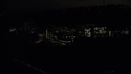 5.5K aerial stock footage flying by and away from the Oregon Health and Science University at night in Portland, Oregon Aerial Stock Footage | AX155_358