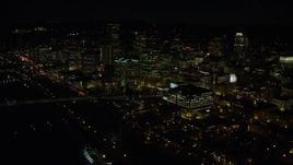 5.5K aerial stock footage of Downtown Portland at night, and reveal the White Stag sign, Oregon Aerial Stock Footage | AX155_370E