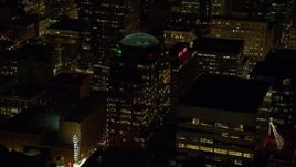 5.5K aerial stock footage approaching 1000 Broadway building and Hilton Portland at night in Downtown Portland, Oregon Aerial Stock Footage | AX155_378