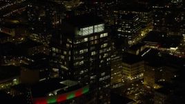 5.5K aerial stock footage flying by and away from Park Avenue West Tower at night in Downtown Portland, Oregon Aerial Stock Footage | AX155_379