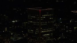 5.5K aerial stock footage orbiting the top of Wells Fargo Center at night in Downtown Portland, Oregon Aerial Stock Footage | AX155_380