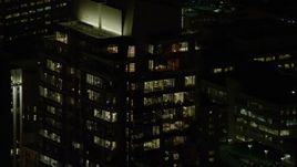 5.5K aerial stock footage of offices on top floors of Park Avenue West Tower at night in Downtown Portland, Oregon Aerial Stock Footage | AX155_384