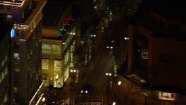 5.5K aerial stock footage orbiting top of Jackson Tower at nighttime in Downtown Portland, Oregon, reveal and track a drone Aerial Stock Footage | AX155_388E
