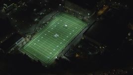 5.5K aerial stock footage of a reverse view of football practice at Portland State University sports field at night, reveal I-405, Downtown Portland, Oregon Aerial Stock Footage | AX155_437