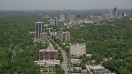 4.8K aerial stock footage following Peachtree Road past office buildings and wooded area, Buckhead, Atlanta, Georgia Aerial Stock Footage | AX36_049E
