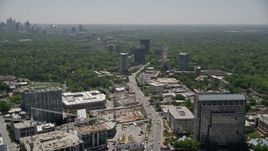 4.8K aerial stock footage tilt from a road by office buildings, reveal downtown skyline, Buckhead, Georgia Aerial Stock Footage | AX36_077E