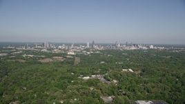4.8K aerial stock footage flying over forests toward Midtown and Downtown Atlanta, Georgia Aerial Stock Footage | AX38_003