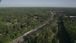 4.8K aerial stock footage orbiting an interstate with heavy traffic bordered by trees, West Atlanta, Georgia Aerial Stock Footage | AX38_032