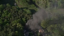4.8K aerial stock footage orbiting smoke from a burning home in a wooded area, West Atlanta Aerial Stock Footage | AX38_036E