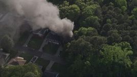 4.8K aerial stock footage circling black smoke from a burning home, West Atlanta, Georgia Aerial Stock Footage | AX38_040E