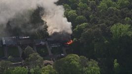 4.8K aerial stock footage approaching and tilt to bird's eye of smoke and flames from a burning home, West Atlanta, Georgia Aerial Stock Footage | AX38_052E