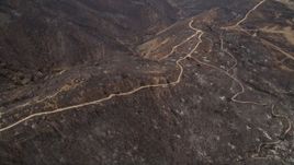 5K aerial stock footage fly over fire damage on a mountain ridge with dirt roads, Santa Monica Mountains, California Aerial Stock Footage | AX42_001