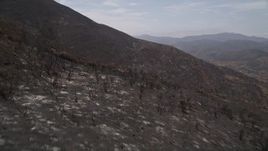 5K aerial stock footage fly over mountain slopes of Santa Monica Mountains damaged by wildfires, California Aerial Stock Footage | AX42_005E