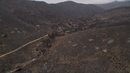 5K aerial stock footage follow and pan across a mountain road through fire-ravaged Santa Monica Mountains, California Aerial Stock Footage | AX42_016