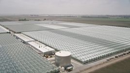 5K aerial stock footage of flying by large greenhouses, Camarillo, California Aerial Stock Footage | AX42_032