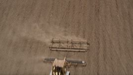 5K aerial stock footage fly over farm field to approach a tractor tilling a field, Camarillo, California Aerial Stock Footage | AX42_038